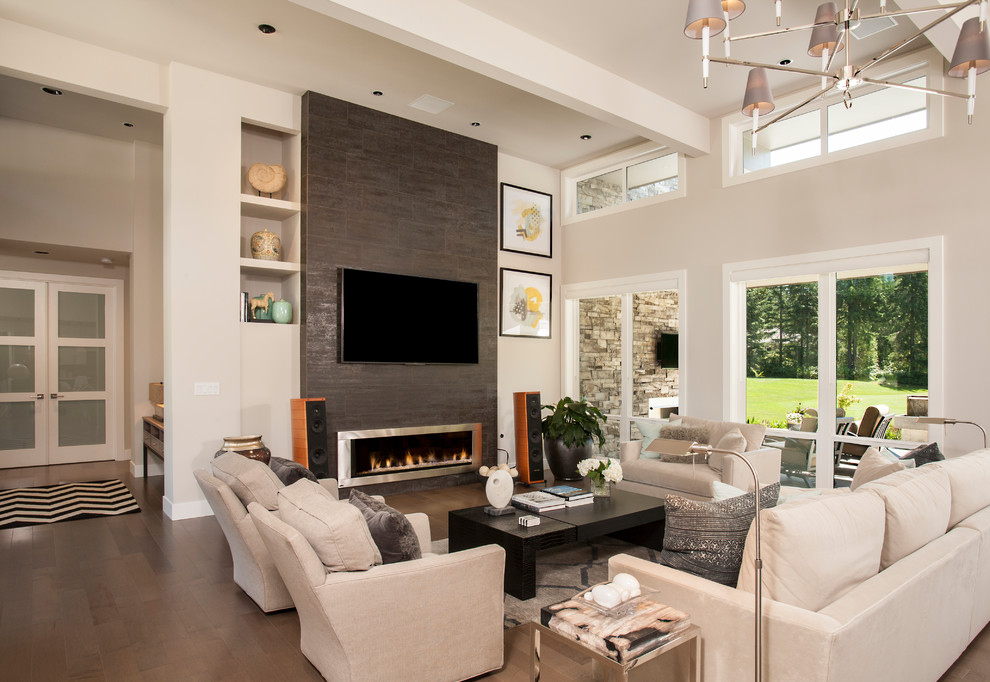 Photo of a contemporary formal open plan living room in Seattle with beige walls, dark hardwood flooring, a ribbon fireplace, a tiled fireplace surround, a wall mounted tv and brown floors.