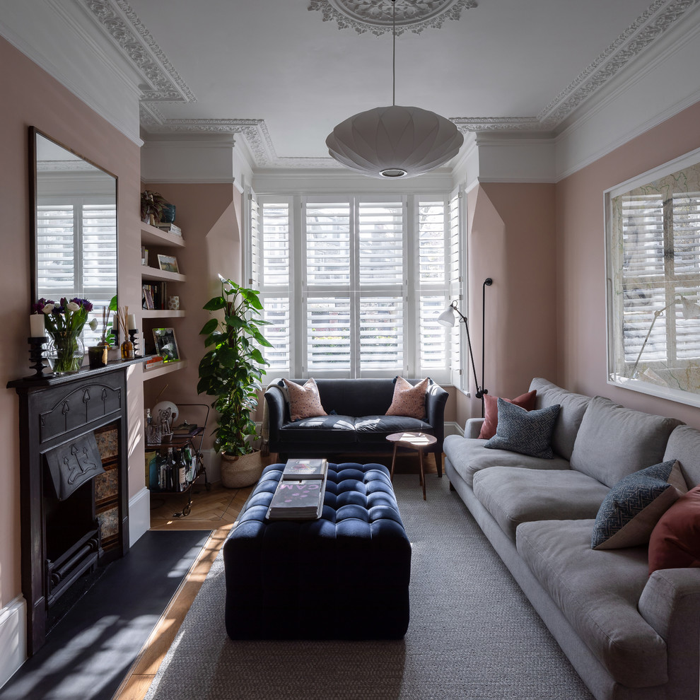 Свежая идея для дизайна: изолированная гостиная комната среднего размера в современном стиле с розовыми стенами, паркетным полом среднего тона, стандартным камином, фасадом камина из плитки и телевизором на стене - отличное фото интерьера