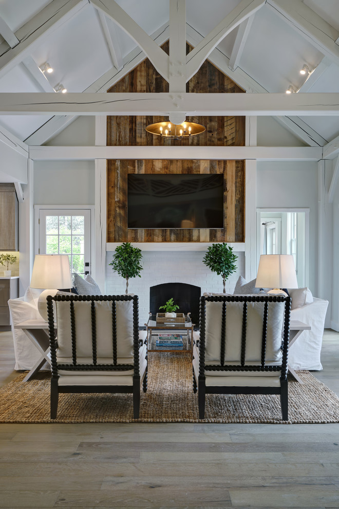 Inspiration for a coastal living room remodel in Other with a wall-mounted tv