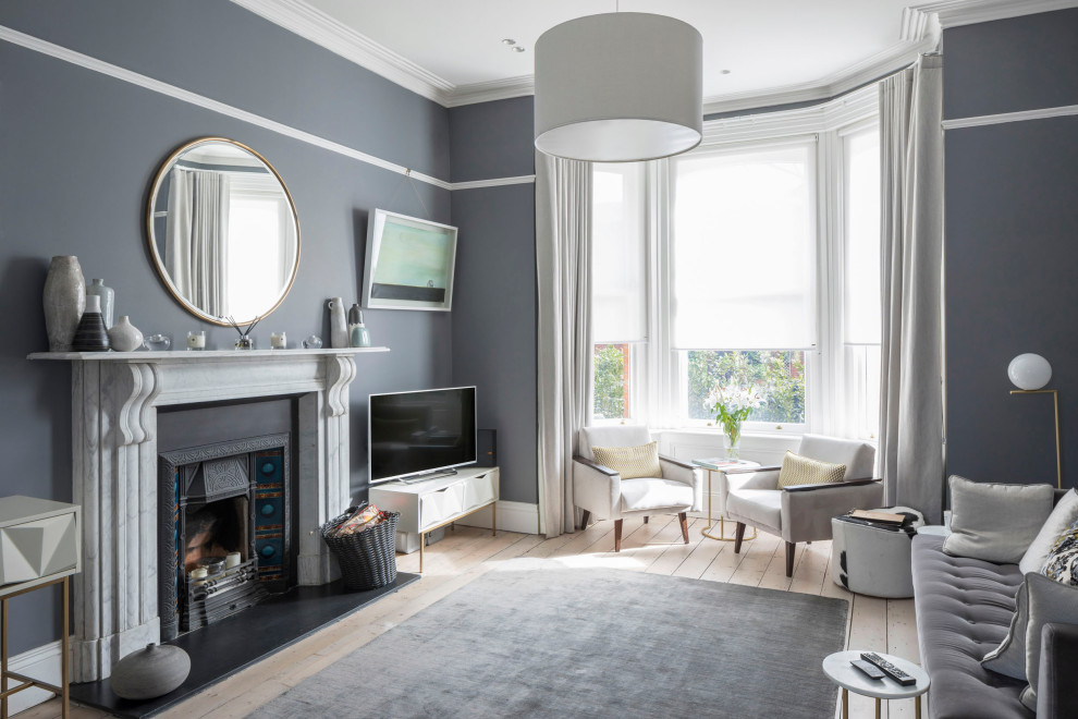 Cette image montre un salon traditionnel ouvert avec un mur bleu, parquet clair, une cheminée standard et un sol beige.