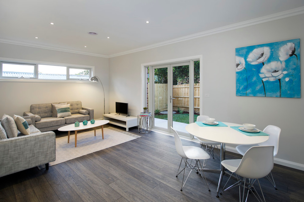 Medium sized contemporary open plan living room in Melbourne with a home bar, white walls, dark hardwood flooring and a freestanding tv.