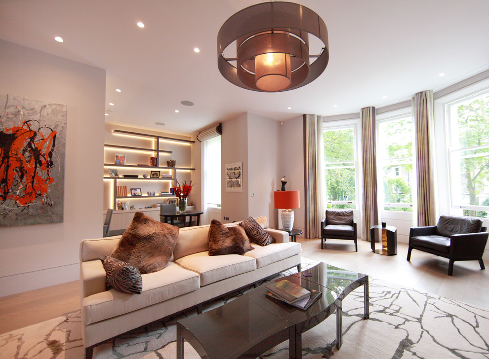 Medium sized contemporary open plan living room in London with light hardwood flooring, a ribbon fireplace, a metal fireplace surround, a freestanding tv and grey walls.