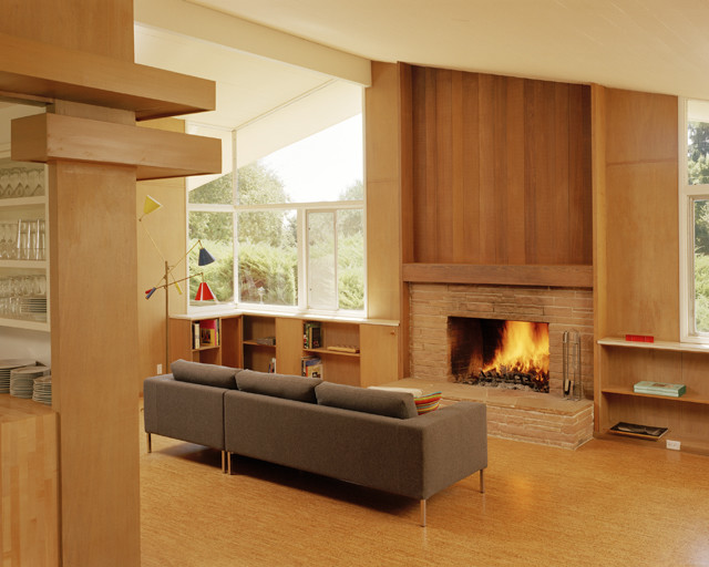 Design ideas for a medium sized modern open plan living room in San Francisco with cork flooring, a standard fireplace, a brick fireplace surround and no tv.