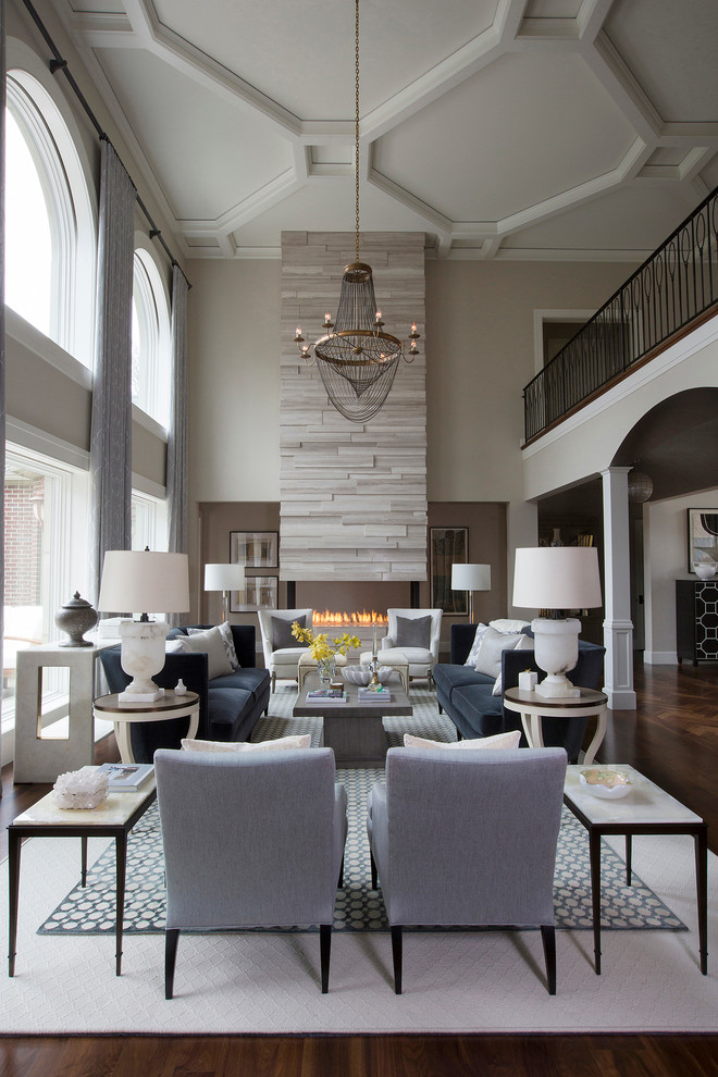 Inspiration for a large transitional formal and open concept medium tone wood floor living room remodel in Other with gray walls, a two-sided fireplace, a stone fireplace and no tv