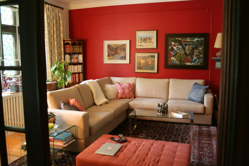 Medium sized eclectic formal open plan living room in Montreal with a corner tv, red walls, medium hardwood flooring, a corner fireplace and a brick fireplace surround.