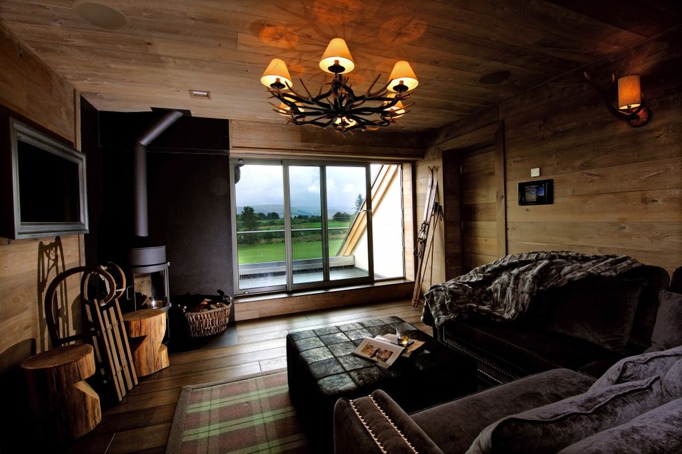 Example of a large mountain style formal and open concept medium tone wood floor living room design in Cheshire with brown walls and a wall-mounted tv