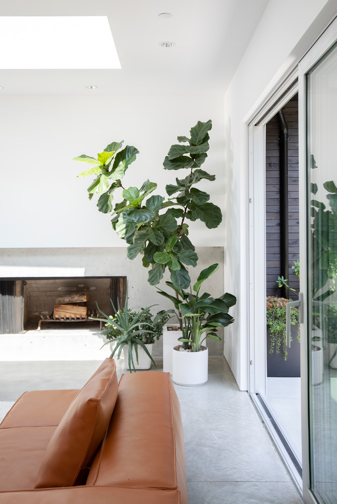 Living room - mid-sized mid-century modern formal and enclosed concrete floor and gray floor living room idea in Vancouver with white walls, a ribbon fireplace, a concrete fireplace and no tv