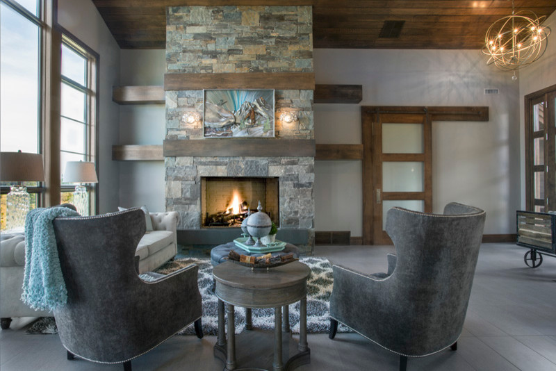 Photo of a large rustic open plan living room in Salt Lake City with grey walls, ceramic flooring, a standard fireplace and a stone fireplace surround.