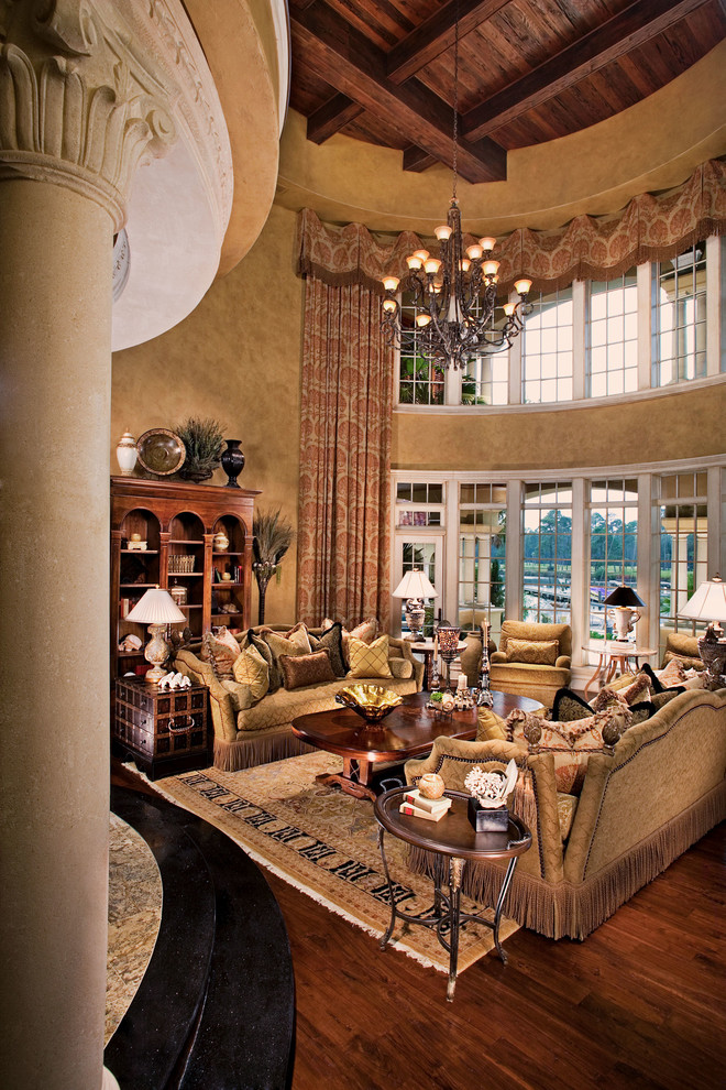 Large tuscan enclosed medium tone wood floor living room photo in Atlanta with beige walls