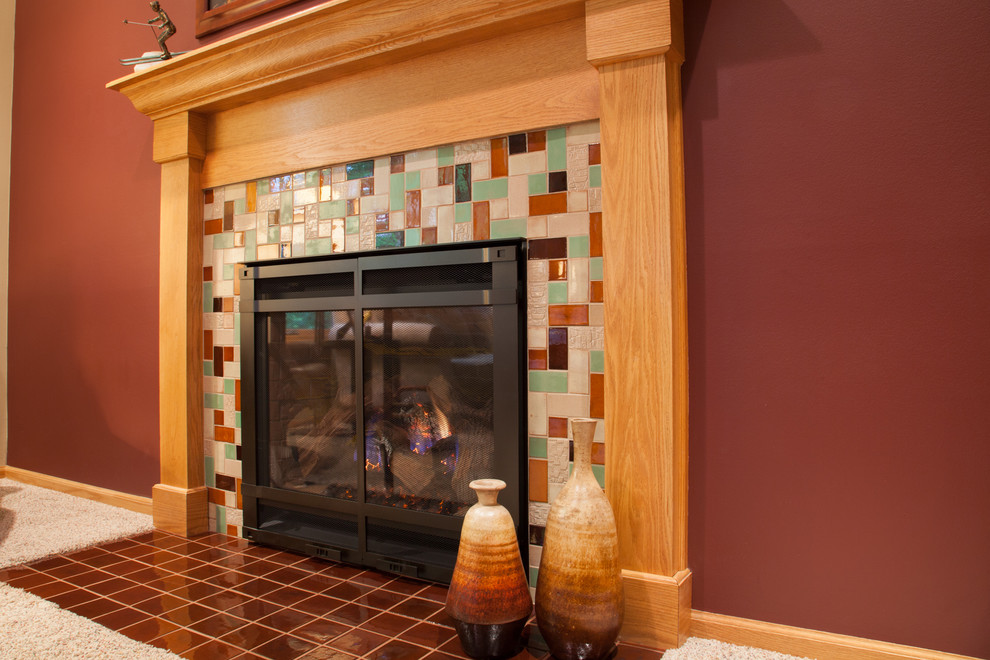 Inspiration for a mid-sized craftsman open concept carpeted living room remodel in Minneapolis with brown walls, a standard fireplace, a tile fireplace and no tv