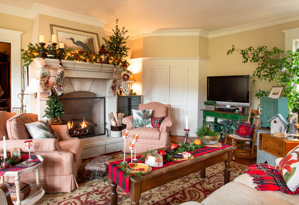 Example of a farmhouse dark wood floor and brown floor living room design in Other with beige walls, a standard fireplace and a tv stand