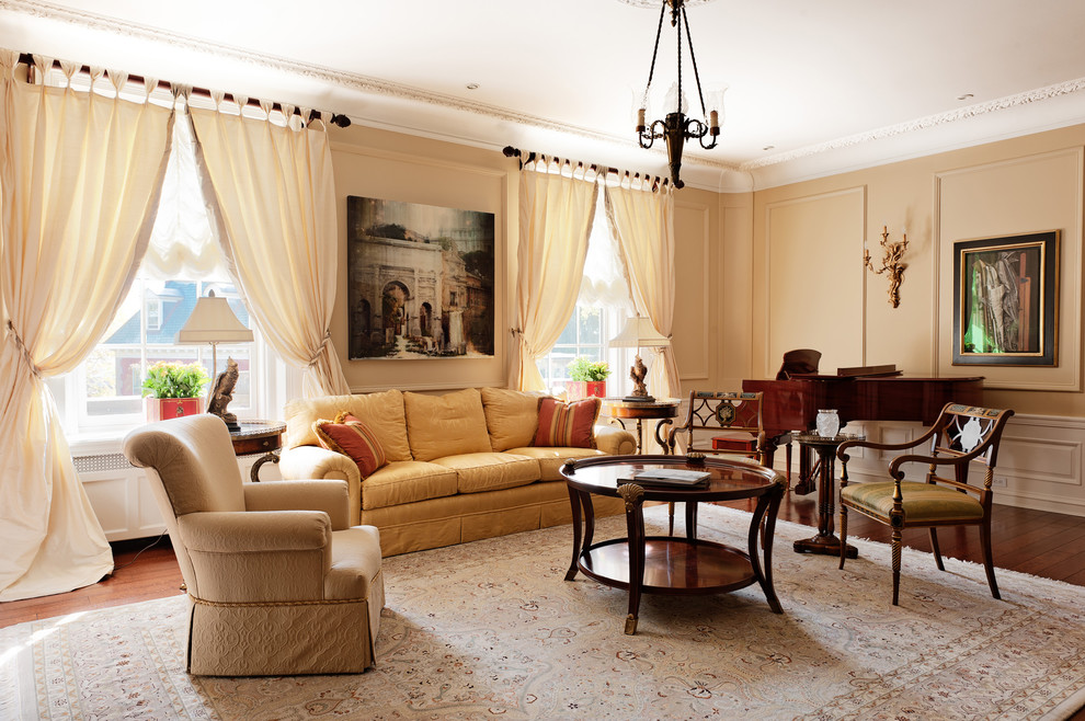 This is an example of a classic living room in Montreal with a music area, beige walls and dark hardwood flooring.