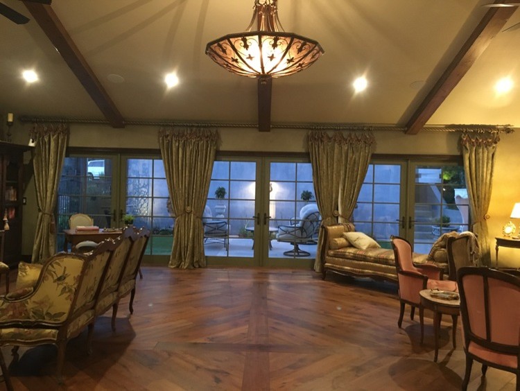 This is an example of a large traditional formal open concept living room in Phoenix with beige walls, dark hardwood floors and brown floor.