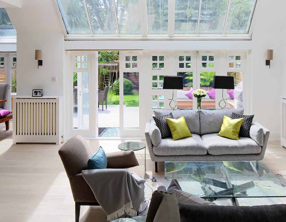 Trendy formal living room photo in London with white walls and no fireplace