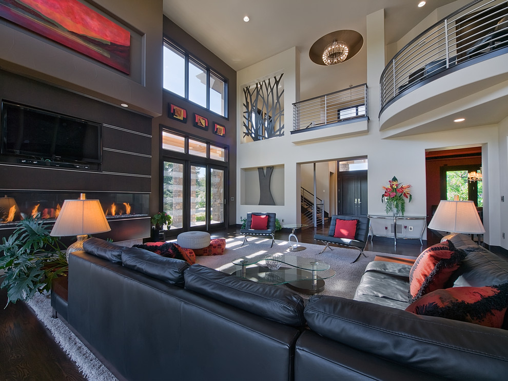 Contemporary living room in Denver with a ribbon fireplace, a wall mounted tv and feature lighting.