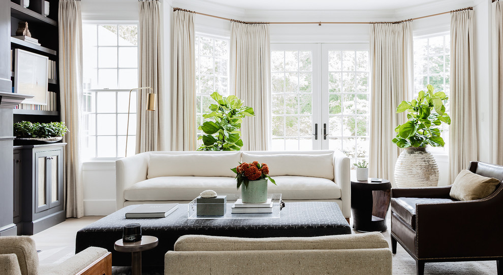 Ispirazione per un soggiorno stile marino con pareti bianche, parquet chiaro, libreria e pavimento beige