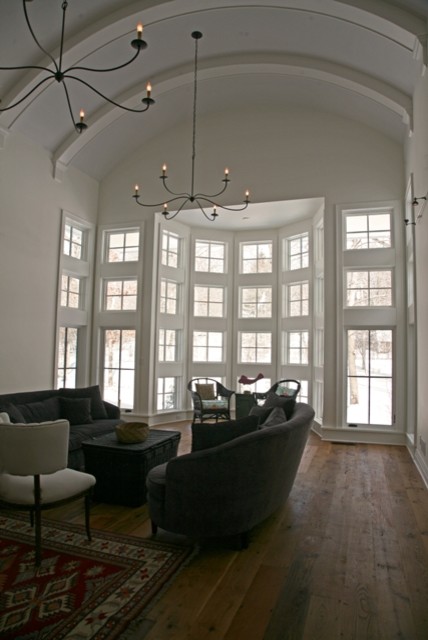 Photo of a large eclectic open plan living room in Milwaukee with medium hardwood flooring and white walls.
