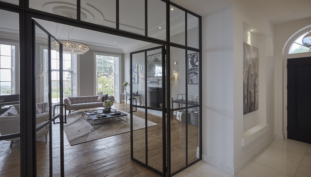 Example of a trendy enclosed medium tone wood floor living room design in Hertfordshire