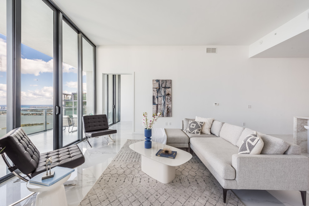 Photo of a large contemporary open plan living room in Miami with marble flooring, no fireplace, white floors and white walls.