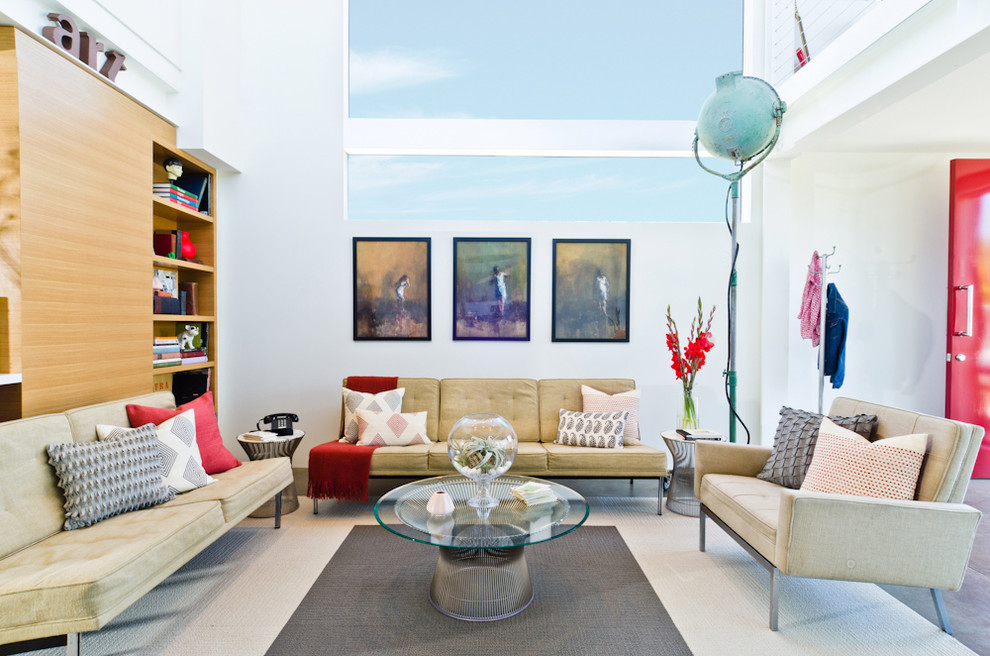 This is an example of a contemporary open plan living room in Los Angeles with a reading nook and white walls.