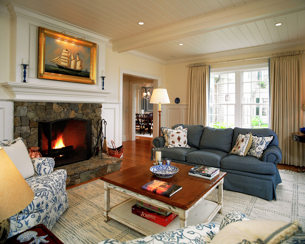 Large traditional formal enclosed living room in Boston with a stone fireplace surround, white walls, medium hardwood flooring and a standard fireplace.