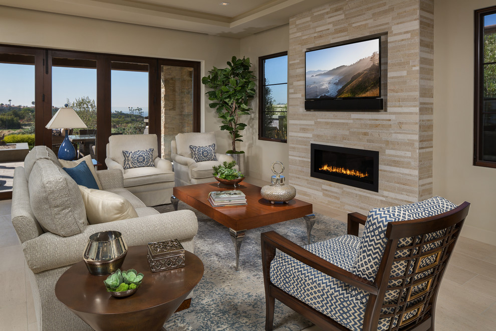 Inspiration for a large timeless open concept and formal limestone floor and beige floor living room remodel in Orange County with beige walls, a ribbon fireplace, a stone fireplace and a wall-mounted tv