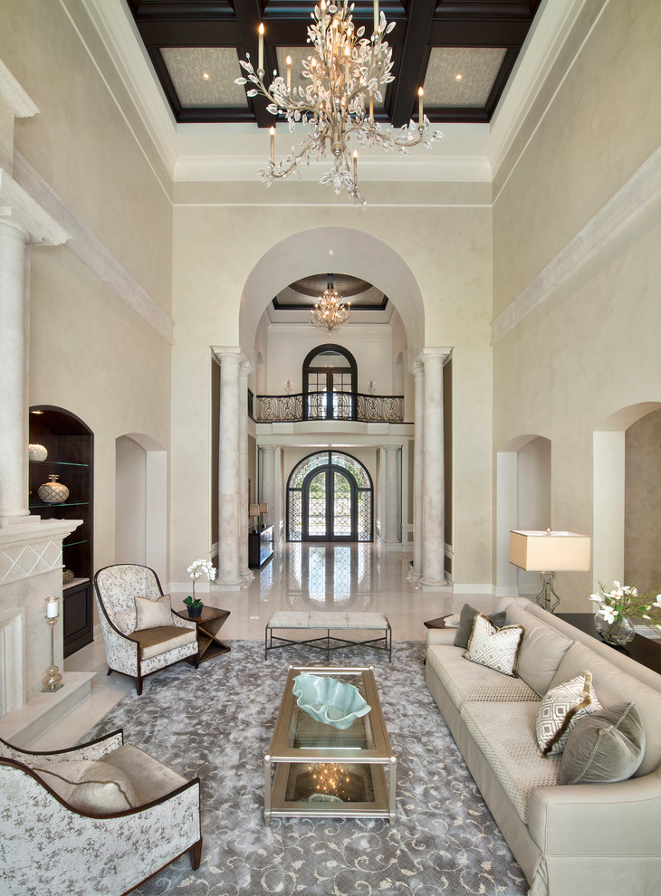 Inspiration for an expansive mediterranean formal open plan living room in Miami with beige walls, marble flooring, a standard fireplace and a stone fireplace surround.
