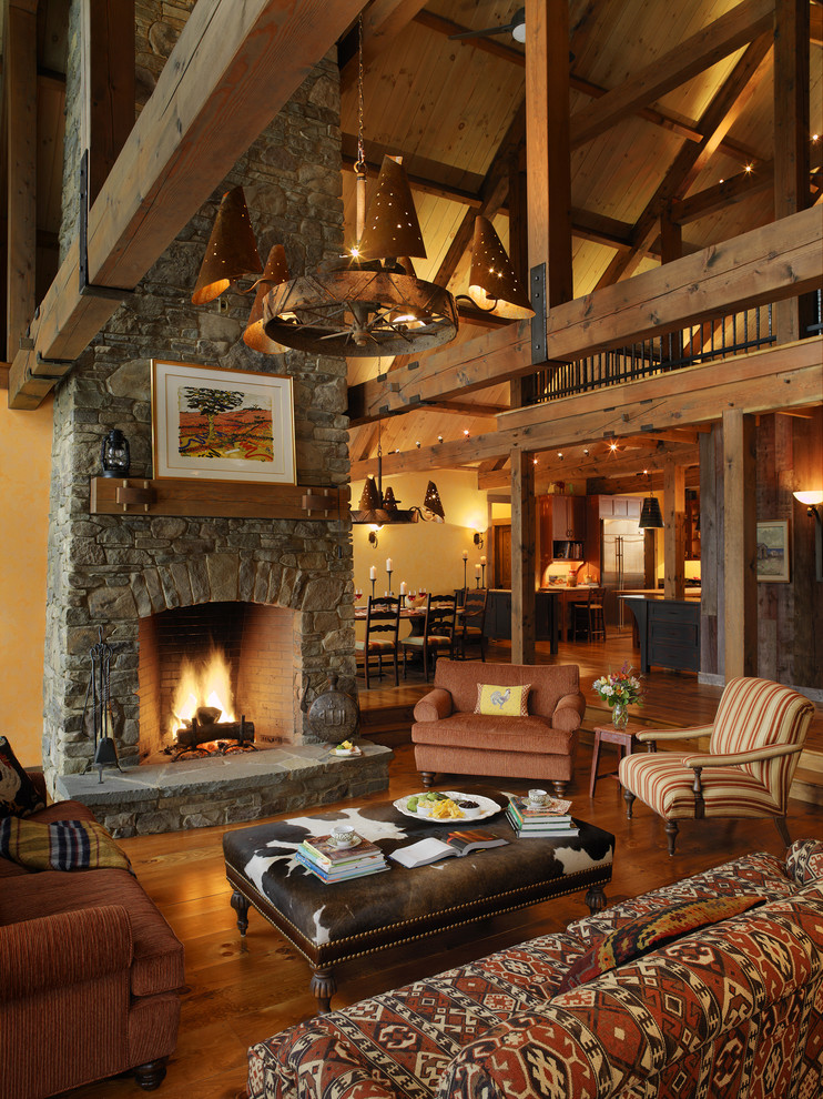 Inspiration for a rustic living room in Burlington with a stone fireplace surround.