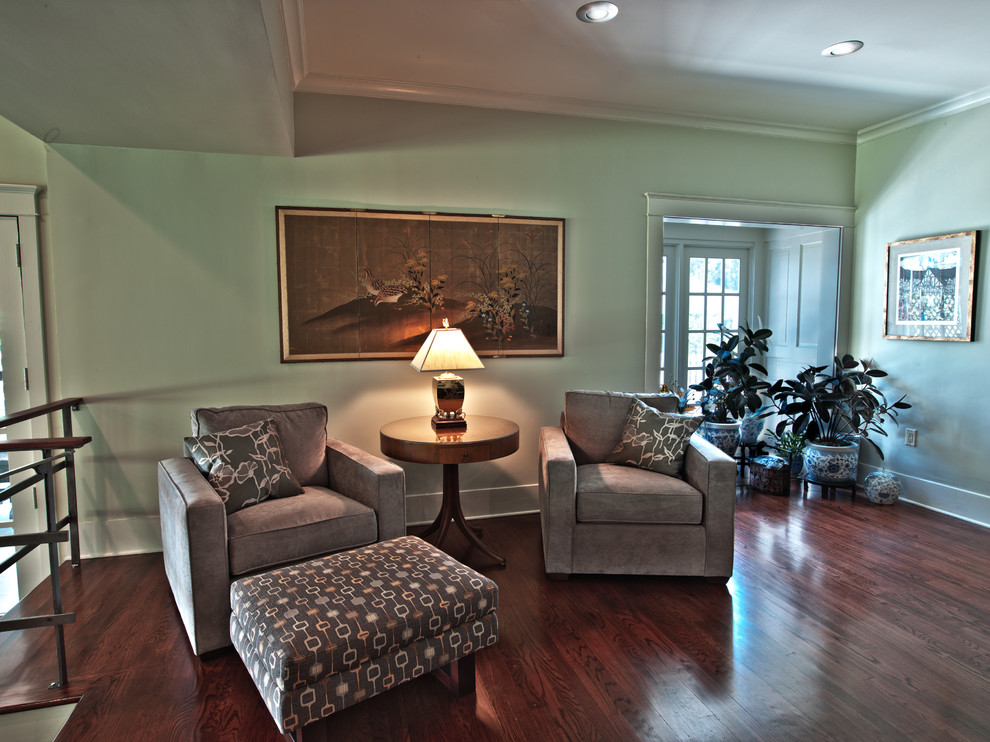 This is an example of a medium sized contemporary formal mezzanine living room in Atlanta with green walls and dark hardwood flooring.