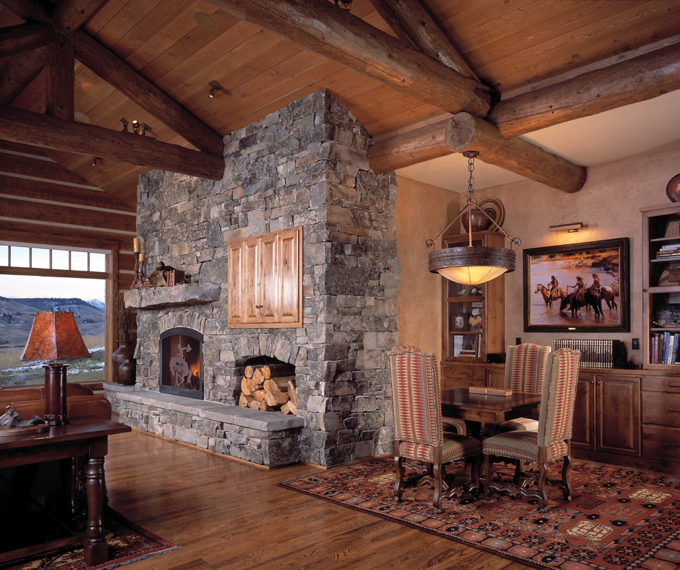 Mid-sized mountain style open concept medium tone wood floor living room photo in Other with beige walls, a standard fireplace and a stone fireplace