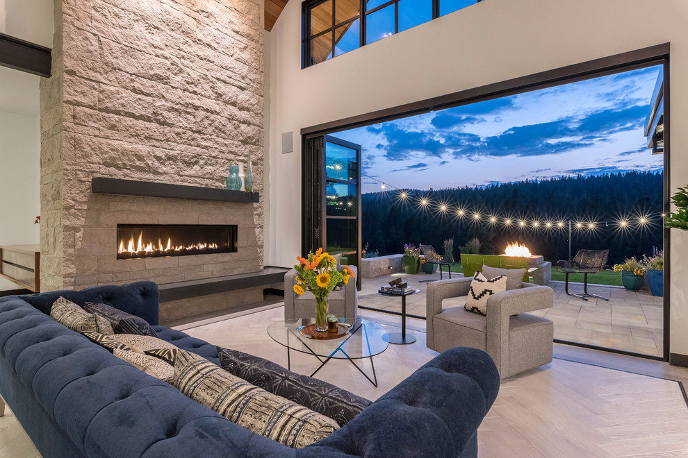 Trendy beige floor living room photo in San Francisco with white walls, a ribbon fireplace and a stone fireplace