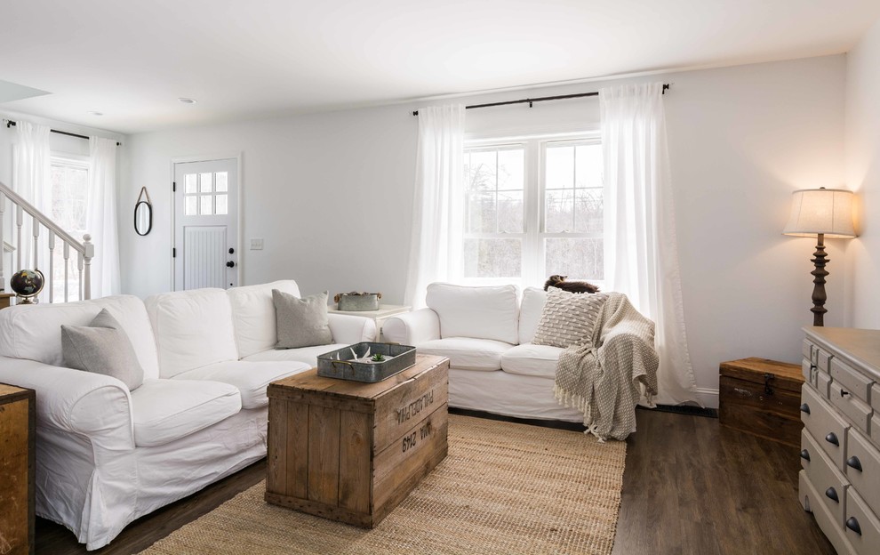 Inspiration for a medium sized country open plan living room in Portland Maine with white walls, vinyl flooring, no fireplace, brown floors and a wall mounted tv.