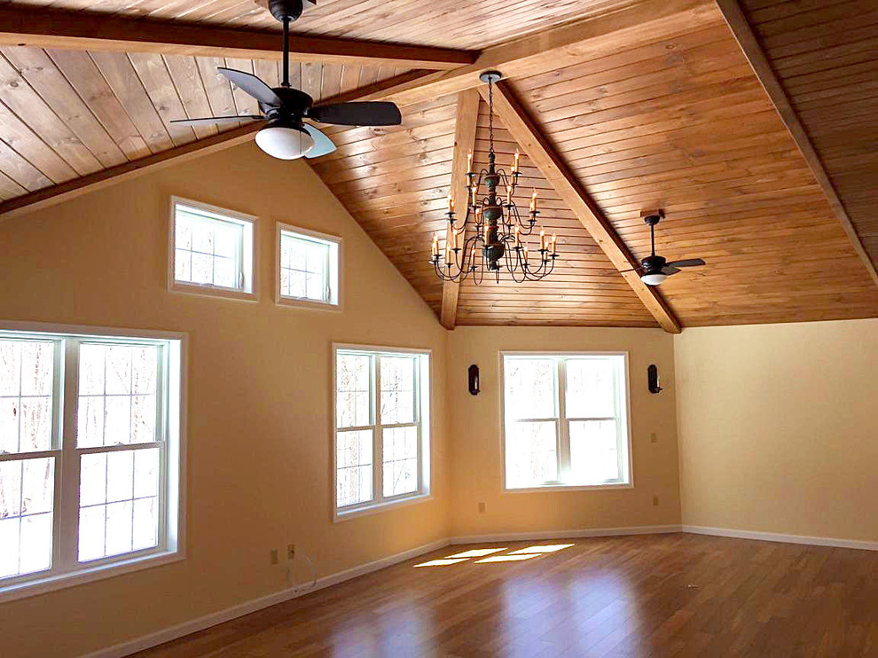 Large arts and crafts enclosed medium tone wood floor living room photo in New York with yellow walls
