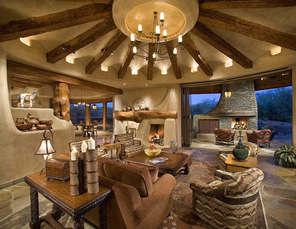 Inspiration for a southwestern open concept living room remodel in Phoenix with beige walls and a standard fireplace