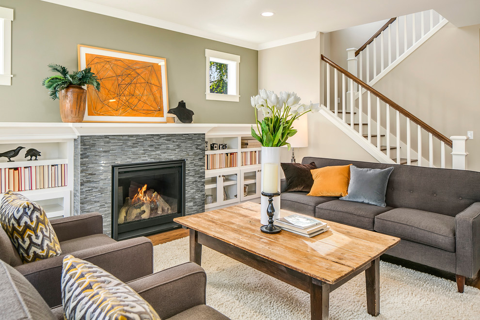 This is an example of a classic open plan living room in Seattle with beige walls, medium hardwood flooring, a standard fireplace and a stone fireplace surround.