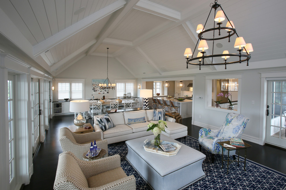 Example of a large beach style open concept dark wood floor living room design in Philadelphia with gray walls and a standard fireplace