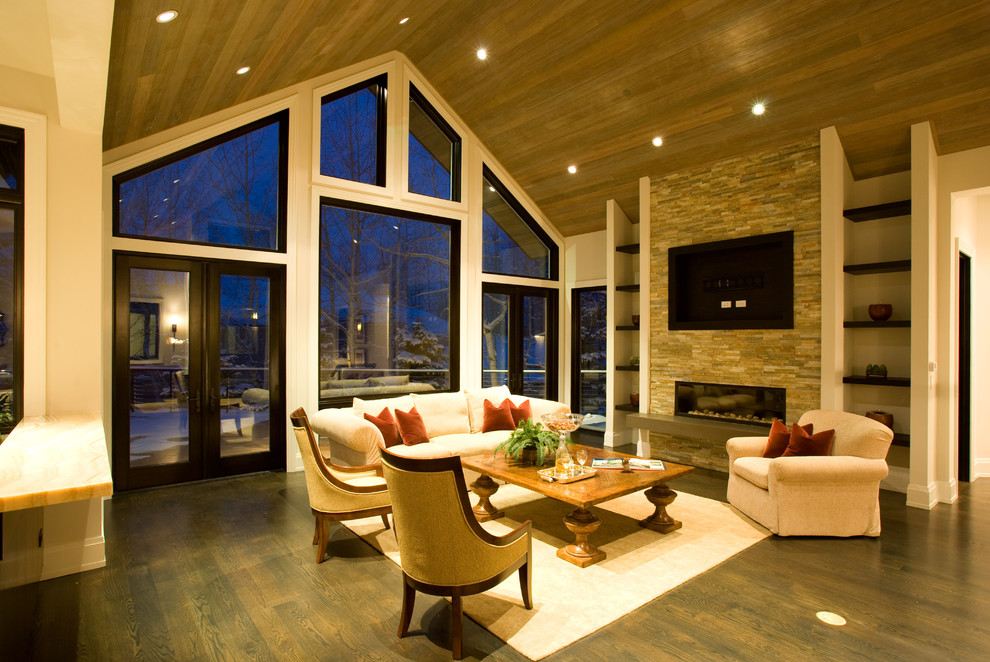 Rustic open plan living room in Denver with dark hardwood flooring, a ribbon fireplace and a wall mounted tv.