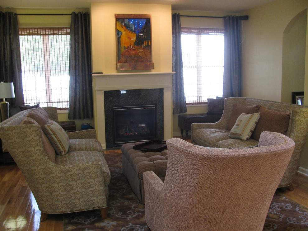 This is an example of a large classic formal open plan living room in Bridgeport with yellow walls, light hardwood flooring, a standard fireplace, a tiled fireplace surround and no tv.