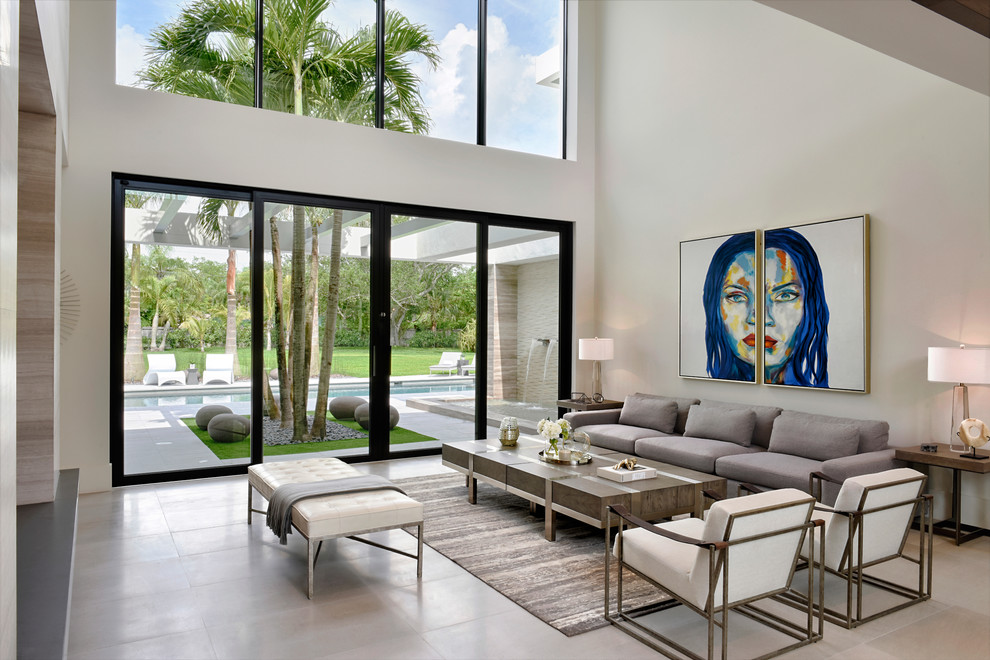 Design ideas for a contemporary formal open plan living room in Miami with white walls, no fireplace, no tv and beige floors.