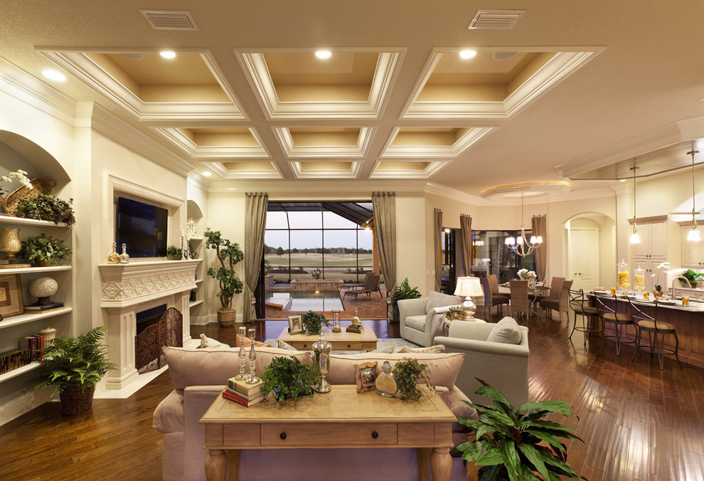 Inspiration for an expansive classic open plan living room in Tampa with a standard fireplace and a wall mounted tv.