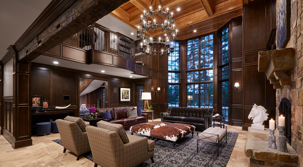 This is an example of an expansive traditional formal mezzanine living room in Minneapolis with brown walls, a standard fireplace, a stone fireplace surround, a built-in media unit, beige floors and limestone flooring.
