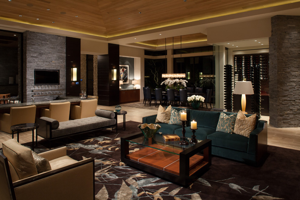 Living room - huge contemporary open concept travertine floor and beige floor living room idea in San Diego with gray walls, a bar and a wall-mounted tv