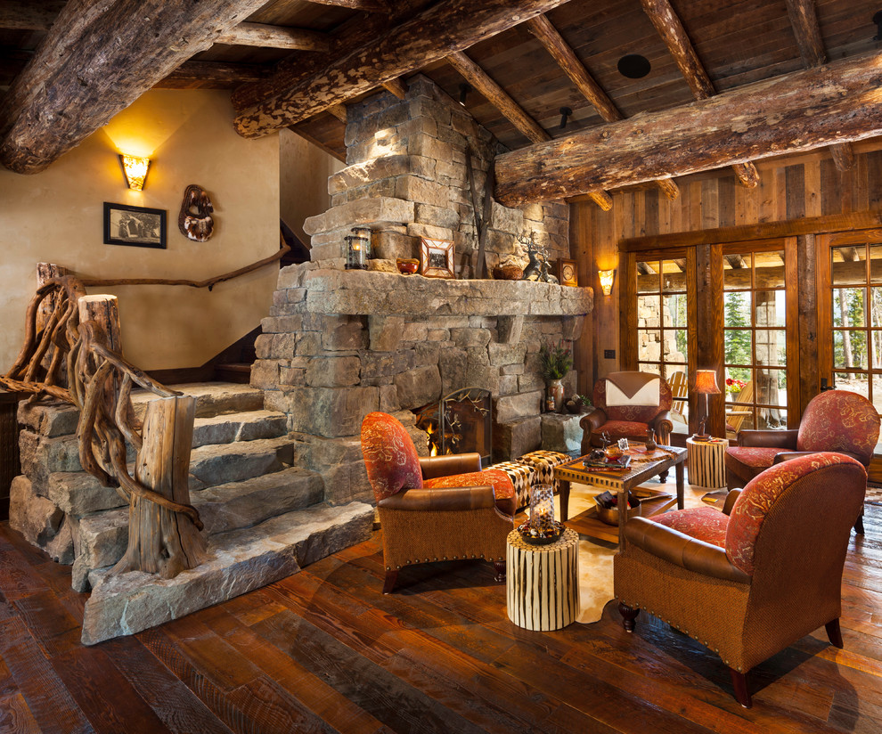 Ejemplo de salón tradicional sin televisor con suelo de madera oscura, todas las chimeneas y marco de chimenea de piedra