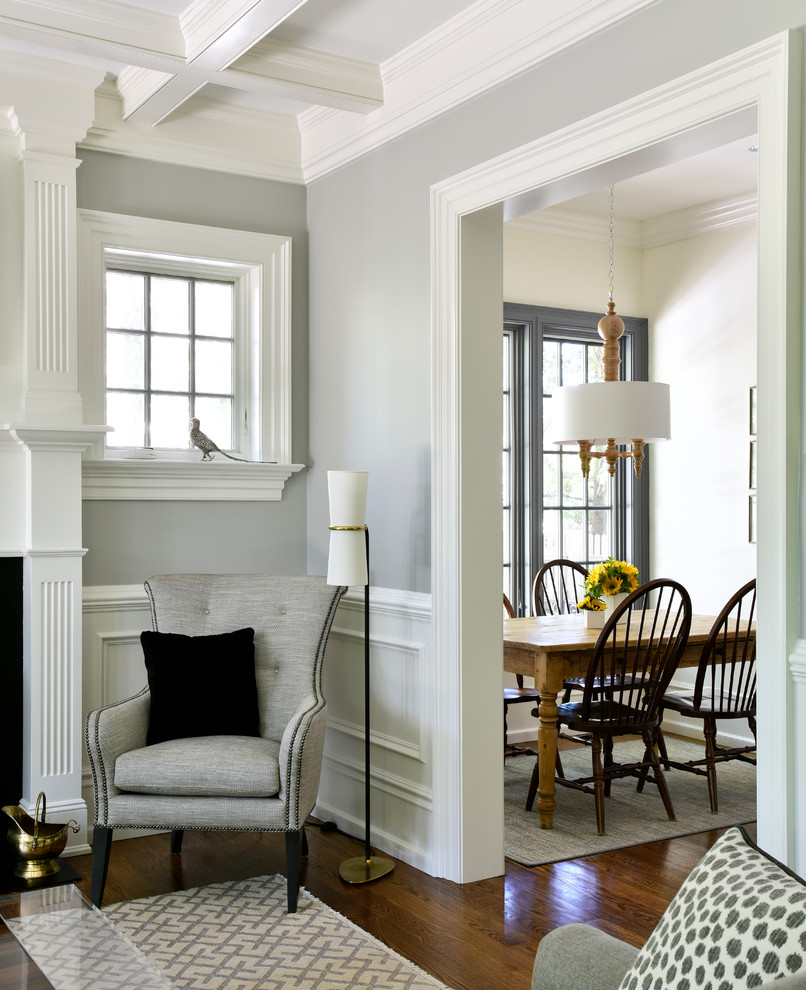 Inspiration för ett mellanstort vintage separat vardagsrum, med ett finrum, grå väggar, mellanmörkt trägolv, en standard öppen spis och brunt golv