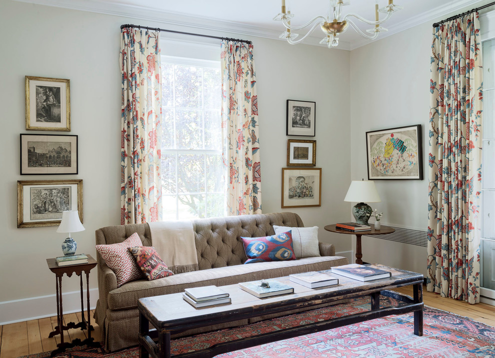 Example of a classic medium tone wood floor living room design in Bridgeport with beige walls
