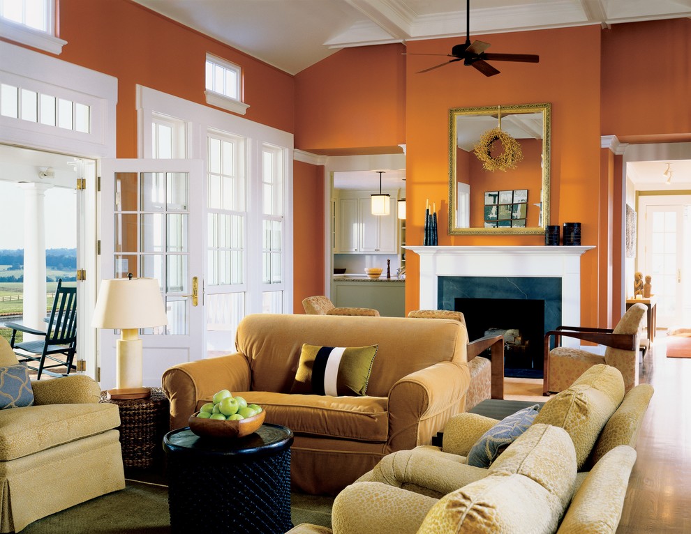 Country living room photo in Richmond with orange walls and a standard fireplace