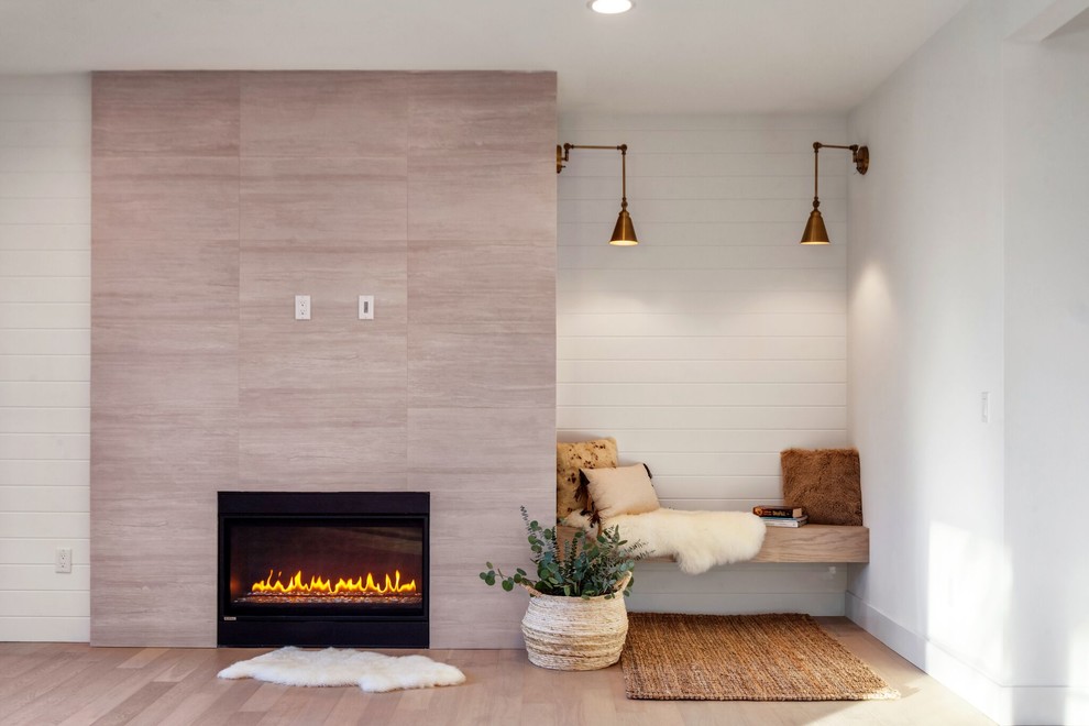 Mittelgroßes Modernes Wohnzimmer mit weißer Wandfarbe, hellem Holzboden, Kamin, gefliester Kaminumrandung und braunem Boden in Seattle