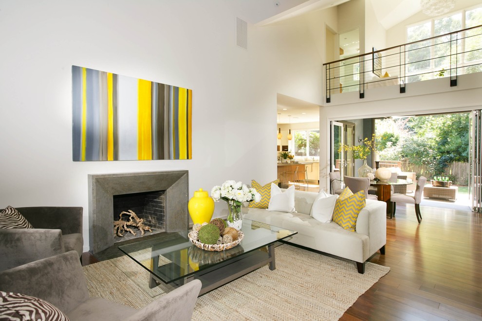 Photo of a medium sized contemporary formal open plan living room in San Francisco with white walls, dark hardwood flooring, a standard fireplace, a concrete fireplace surround and no tv.