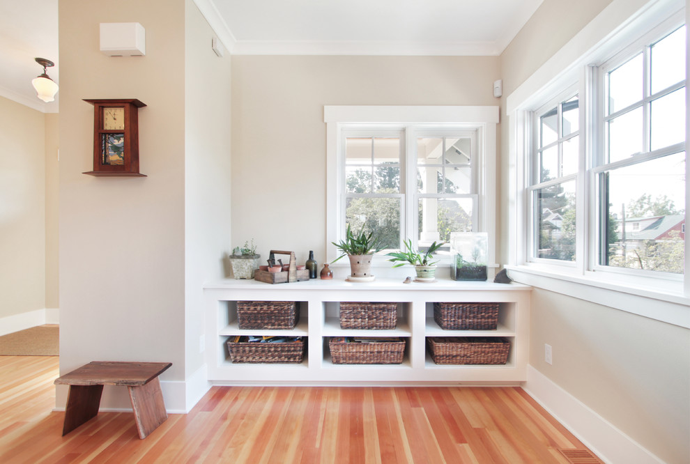 This is an example of a medium sized traditional open plan living room in Seattle with white walls, medium hardwood flooring and no tv.