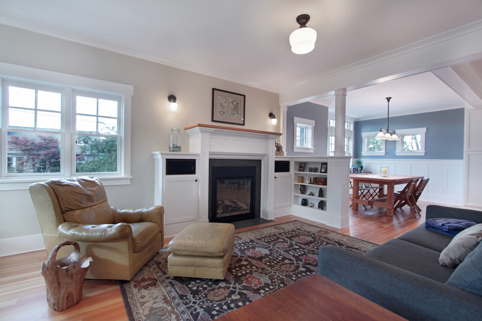 Mittelgroßes, Offenes Rustikales Wohnzimmer mit grauer Wandfarbe, braunem Holzboden, Kamin, gefliester Kaminumrandung und braunem Boden in Seattle